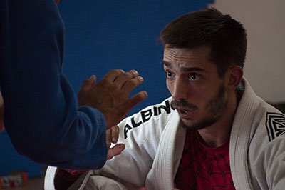 A BJJ player trains with his partner as they both fight for the top position.