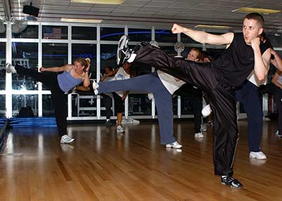 A class for American style kickboxing with students learning kicks.