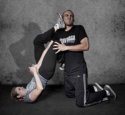 A woman attempting an armbar submission using Krav Maga.