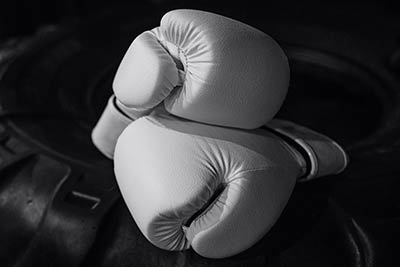 A pair of boxing gloves sitting on a table.