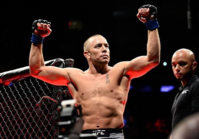 UFC welterweight king Georges St Pierre enters the octagon before his fight.