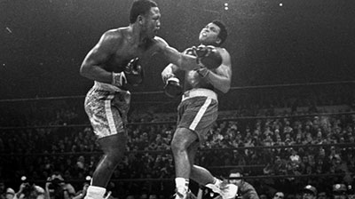 Legendary heavyweight Joe Frazier lands a stinging gazelle punch on Muhammed Ali.