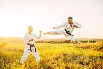 Two Karate fighters do a demonstration outdoors.