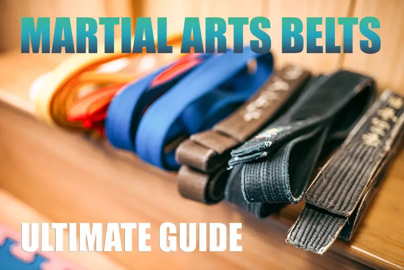 Several martial arts belts on a table.